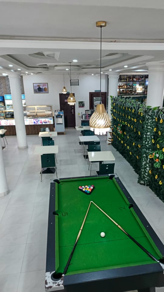 Pool table lounge at Jogik with the bar and dining area in the background