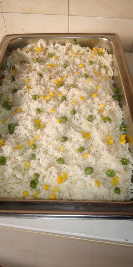 Chafing dish of white rice with peas and sweet corn